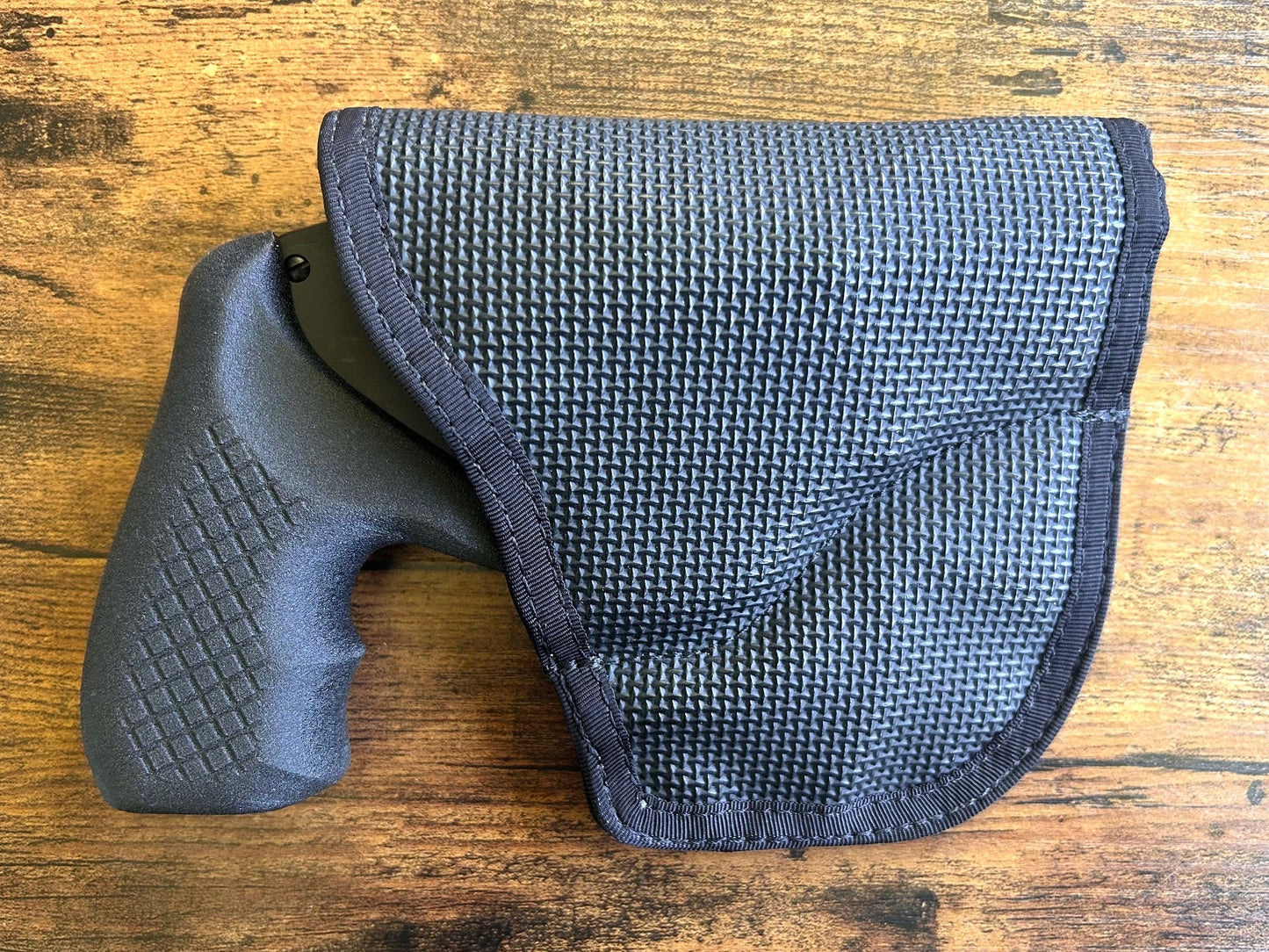Internal hammer j-frame (model 642/442/340) with Recoil Rider boot grips and DeSantis gunhide holster for pocket carry.