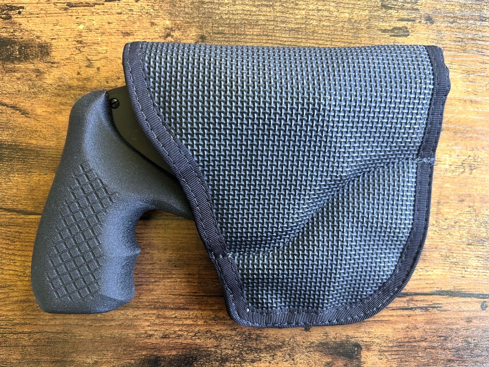 Internal hammer j-frame (model 642/442/340) with Recoil Rider boot grips and DeSantis gunhide holster for pocket carry.